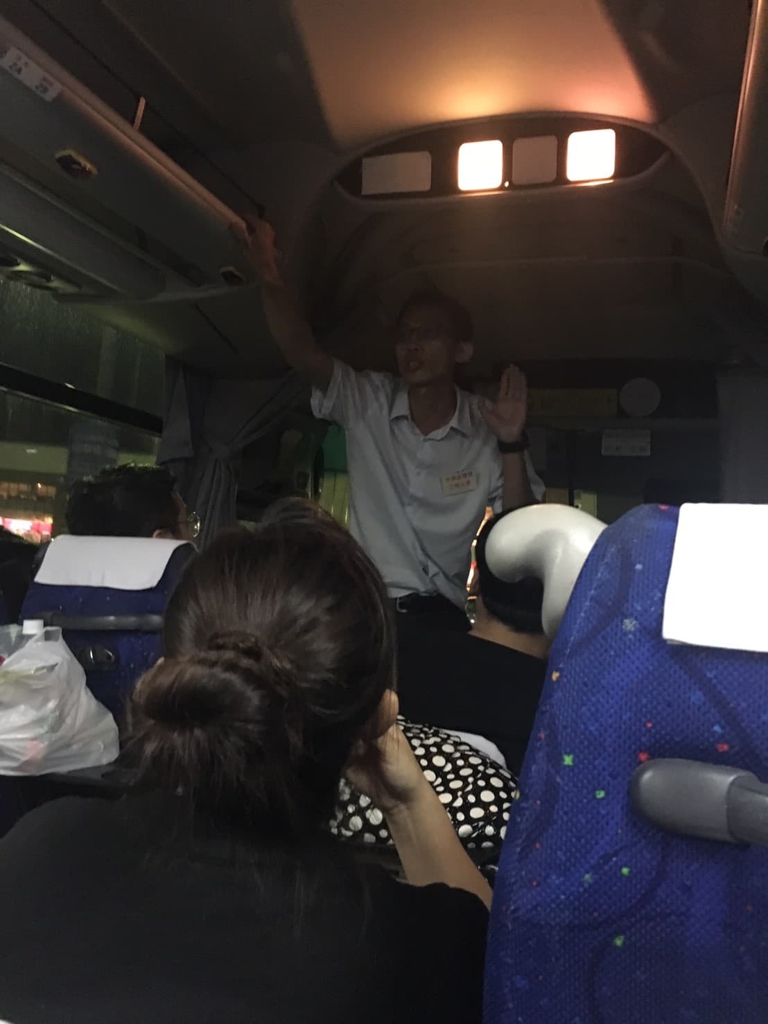 巴士上有負責人向中國旅客解釋疏散情況。(民眾提供)