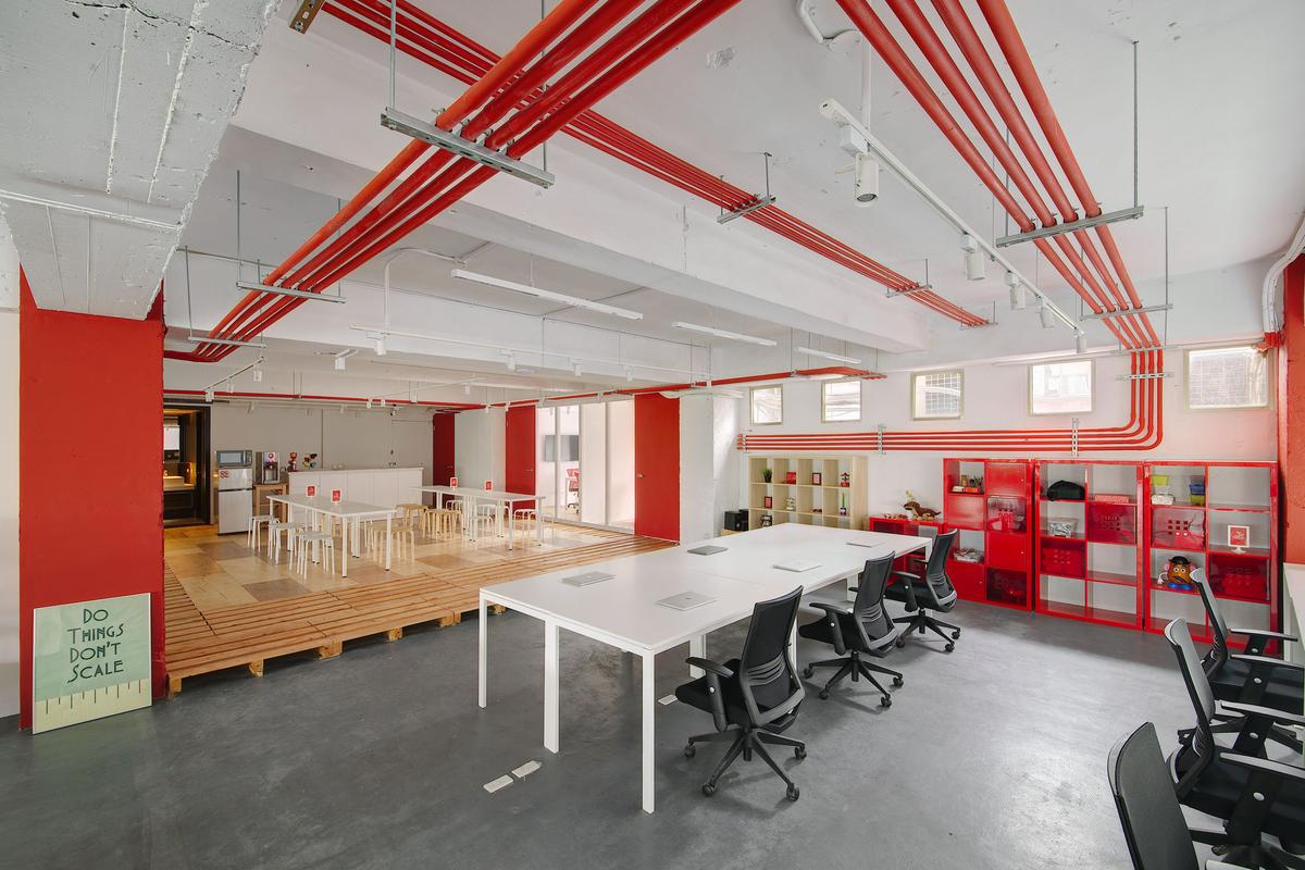 有偶幫旋轉拍賣台灣分公司設計的辦公室，採用刻意外露的紅色管線沿著天花、壁面彎轉，呼應社群網路世界的延伸。（有偶設計提供）